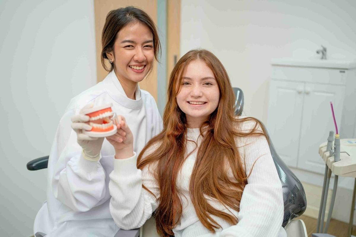 Dentist and patient discussing dental implant options in a modern dental office