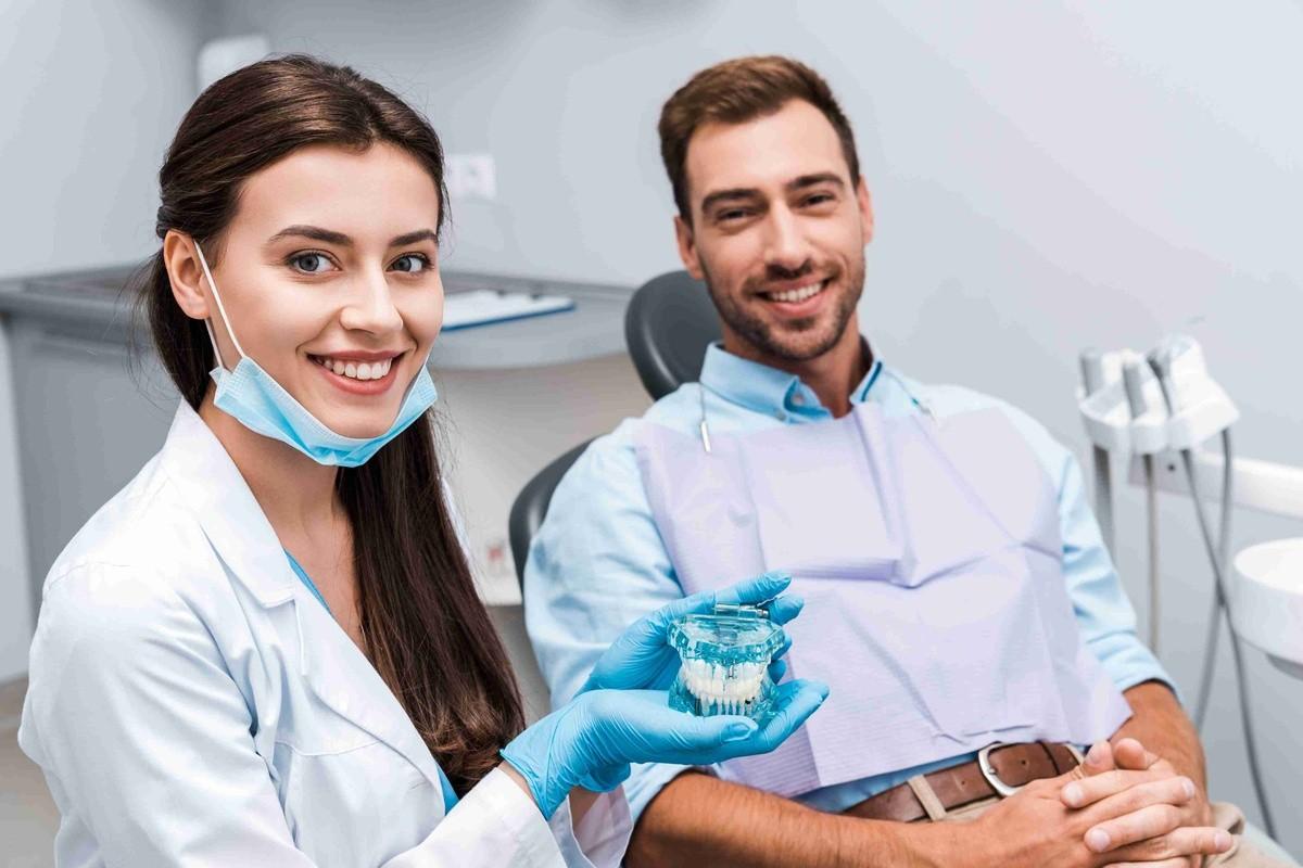 Dentist discussing dental implant options with a patient during a consultation