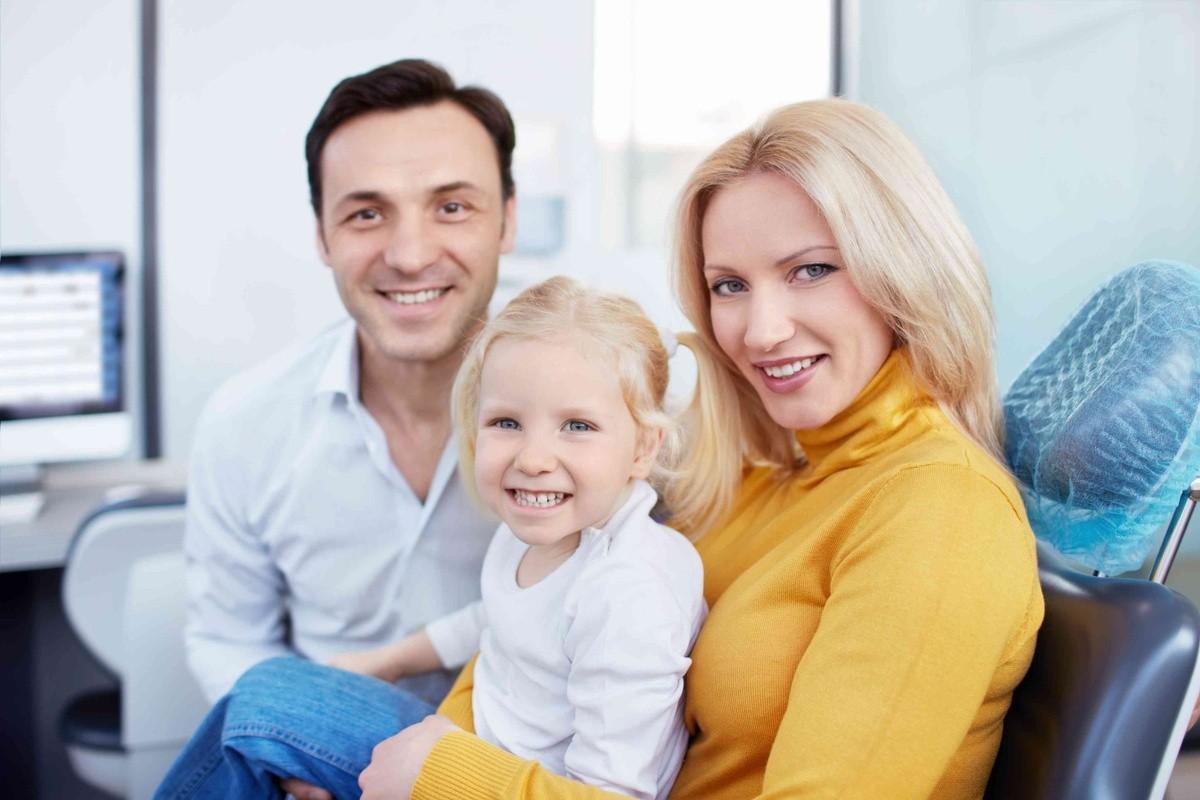 Parents with a child at dental office for family dental care