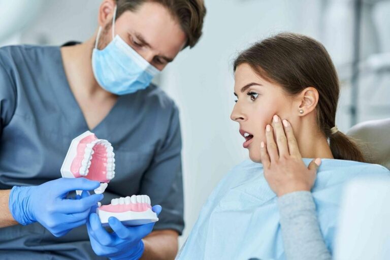 Dentist explaining root canal treatment options to a patient experiencing tooth pain