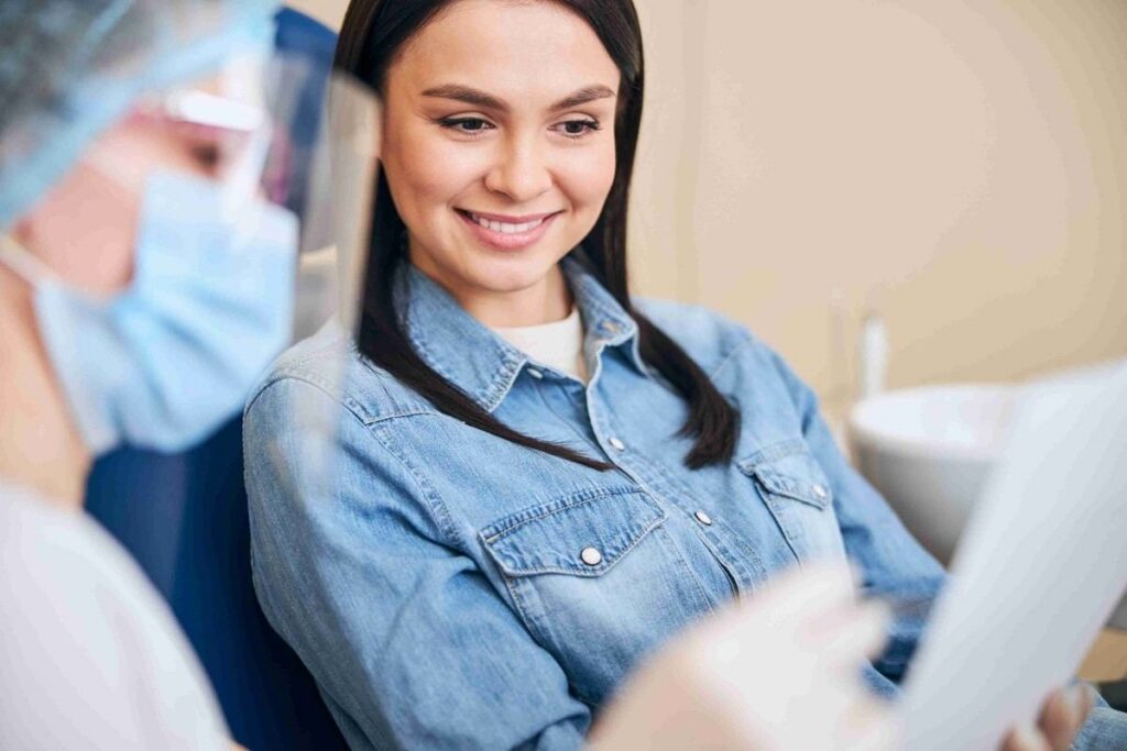 Woman discussing clear aligner treatment with a dentist for straighter teeth