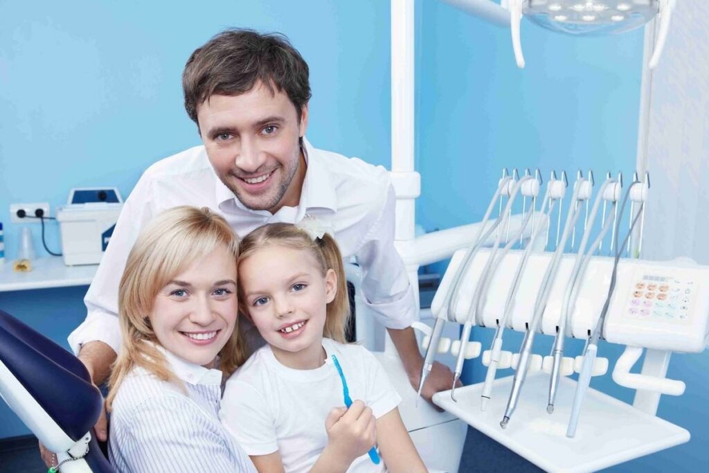 Family dentist with parents and child supporting everyday oral health care